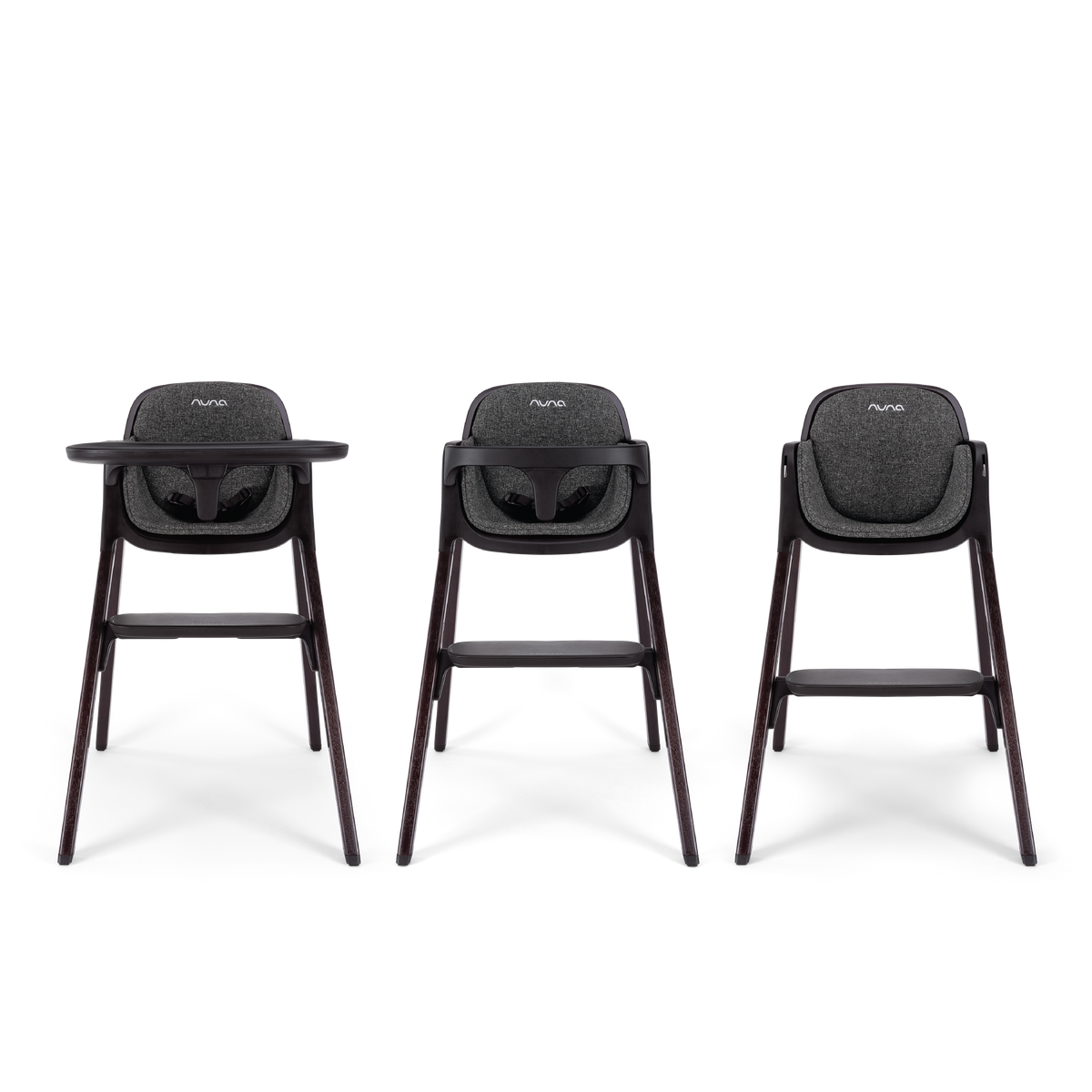 Three nuna bryn highchairs with dark gray fabric seats and sleek wooden legs shown from the front