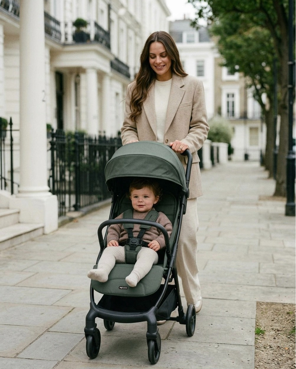 My Babiie MBX6 auto fold compact stroller in forest green dark green fabric with black metal frame and wheels