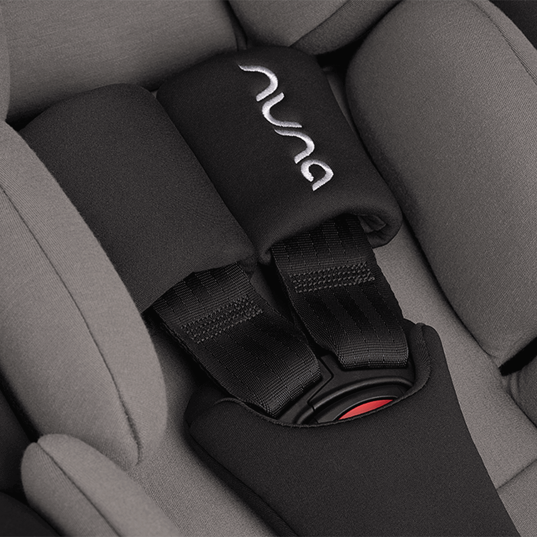 Black nuna seat belt cover with silver embroidered logo and red buckle accent for nuna arra flex car seat