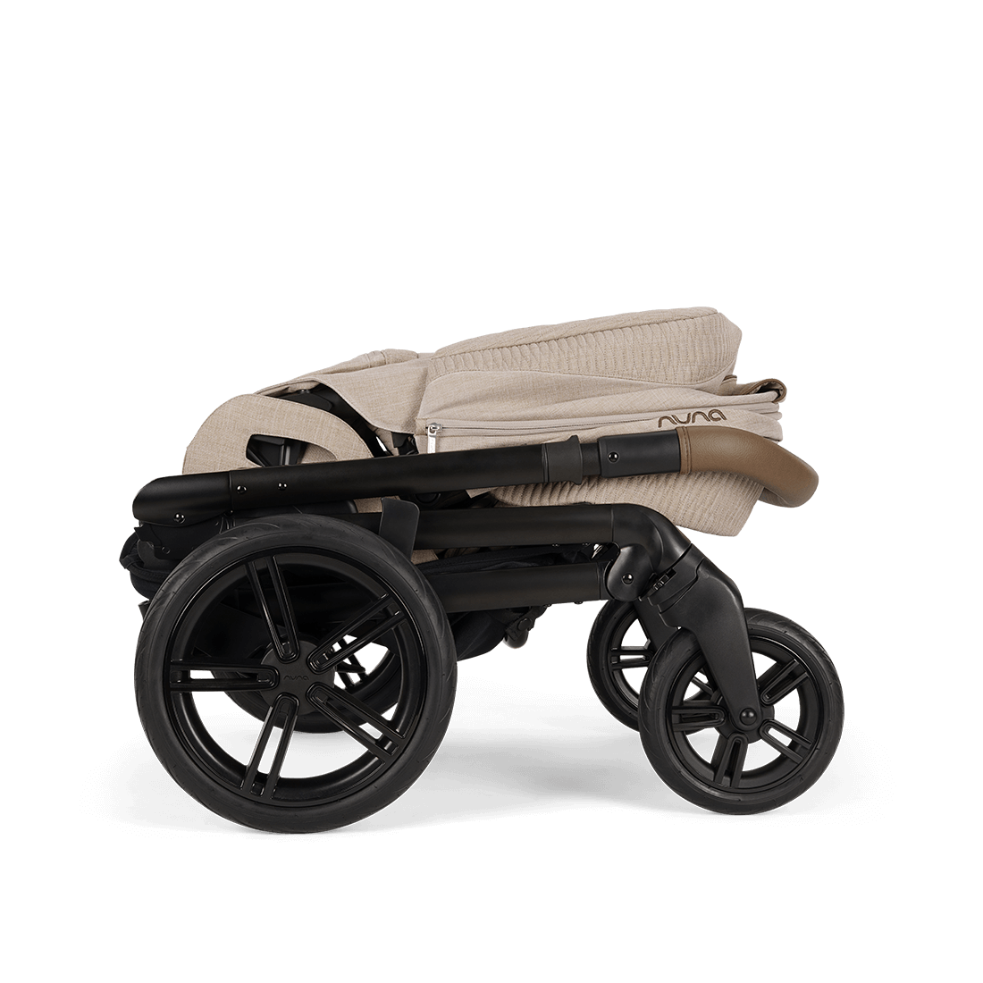 Beige and black nuna mixx next stroller with soft quilted fabric canopy and sleek modern frame in cosmopolitan style