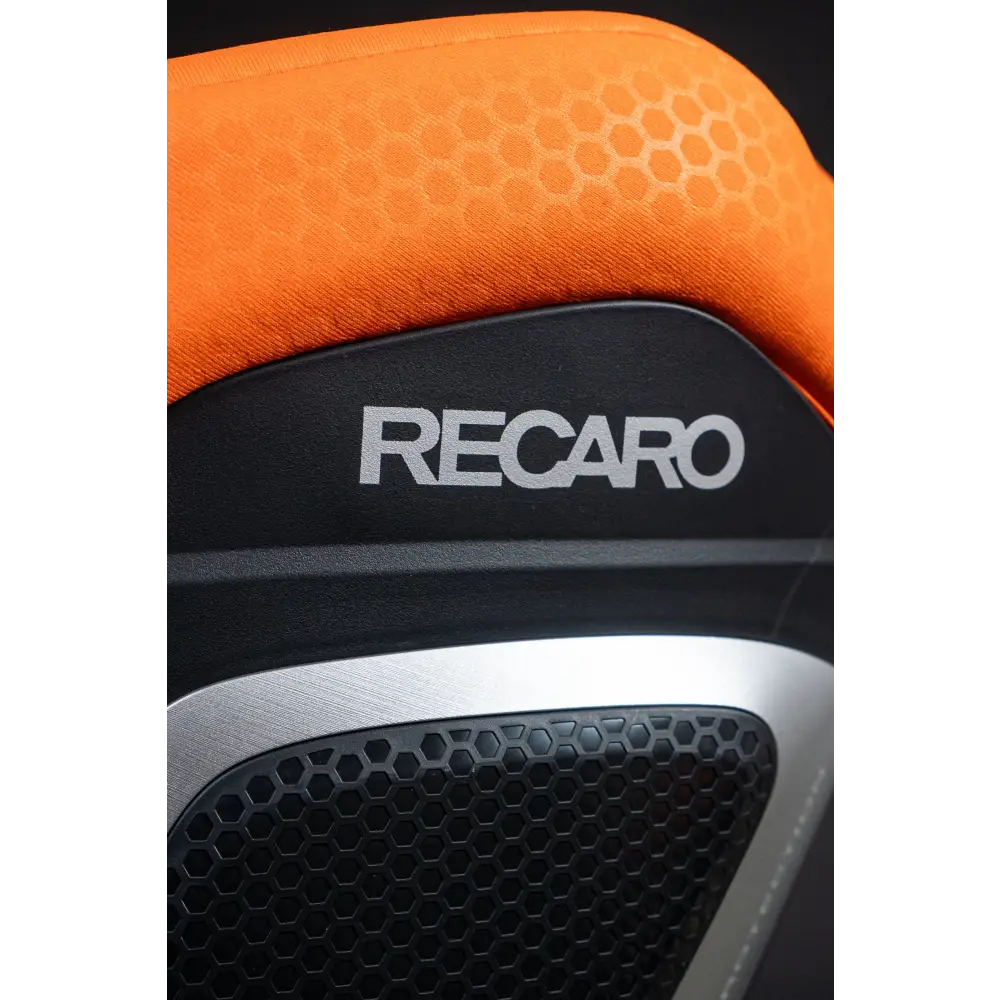Close-up of the XENON 1’s orange upholstery, white Recaro logo and silver-trimmed honeycomb side panel.