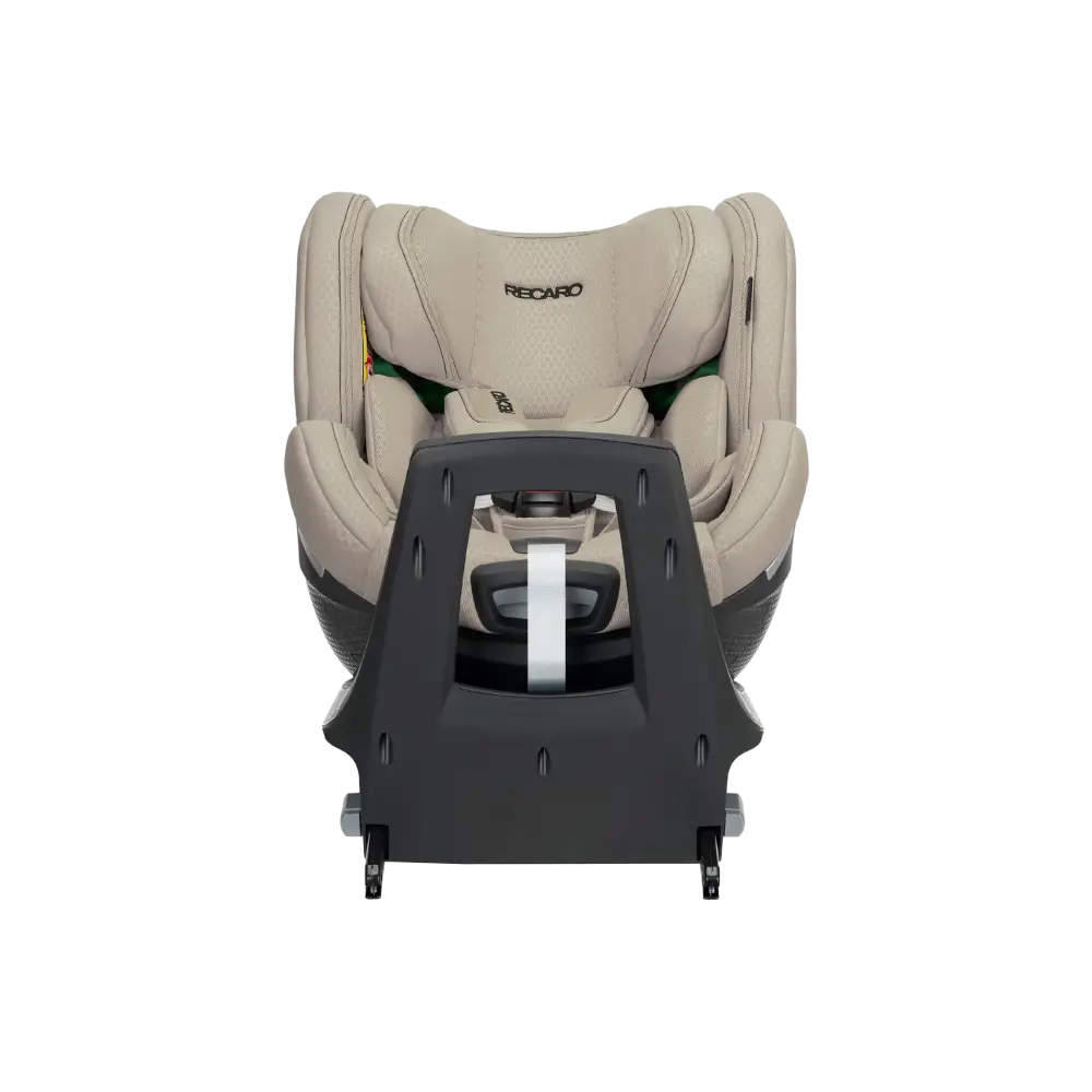 Elegant Beige XENON 1 KID with padded harness, viewed across the tall black panel at the end of its base.