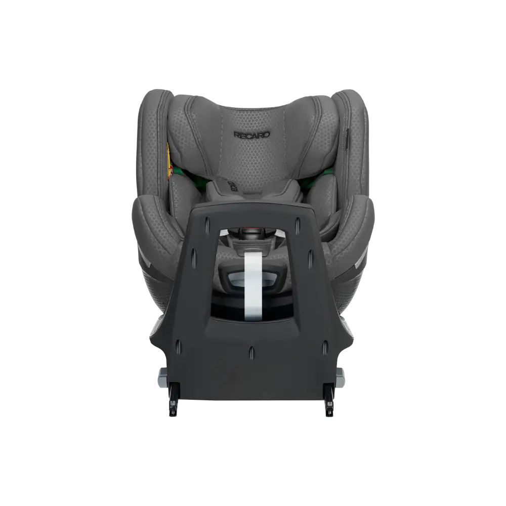 Recaro Gallant Grey XENON 1 KID with padded harness, viewed across the tall black panel at the end of its base.