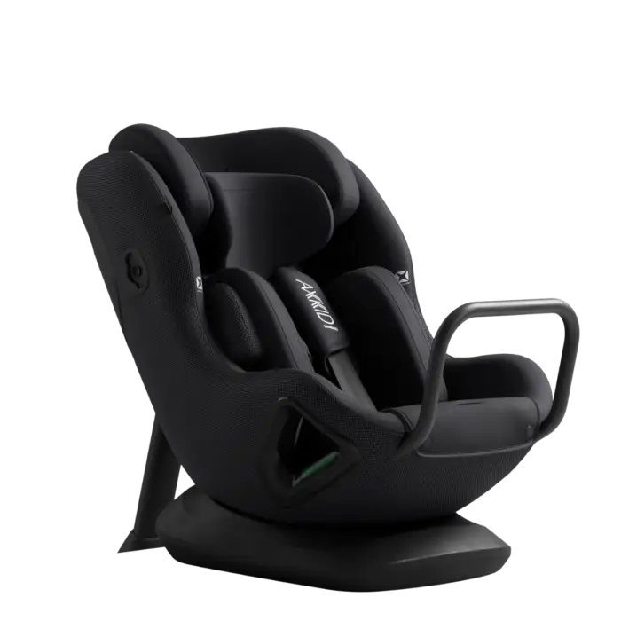 Black Axkid Minikid Core child safety seat with padded contours and sleek modern design for rear facing use