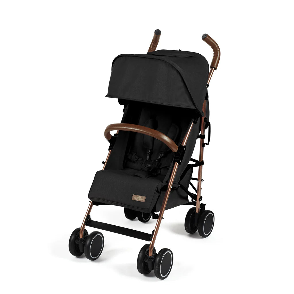 Black ickle bubba discovery max stroller with rose gold metallic frame and brown leather handles visible from the back