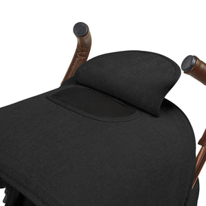 Black padded headrest with mesh ventilation panel mounted on brown leather wrapped handles of ickle bubba discovery max stroller back side