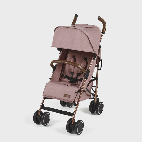 Ickle Bubba Discovery stroller in dusky pink with rose gold frame, blush pink fabric, black wheels, and brown leather handles