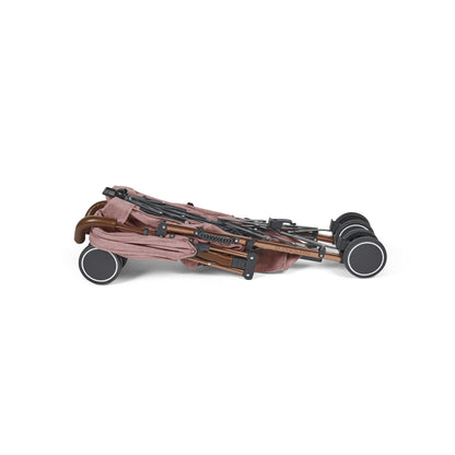 Folding stroller with rose gold frame and dusty pink fabric canopy ickle bubba discovery max stroller dusky pink