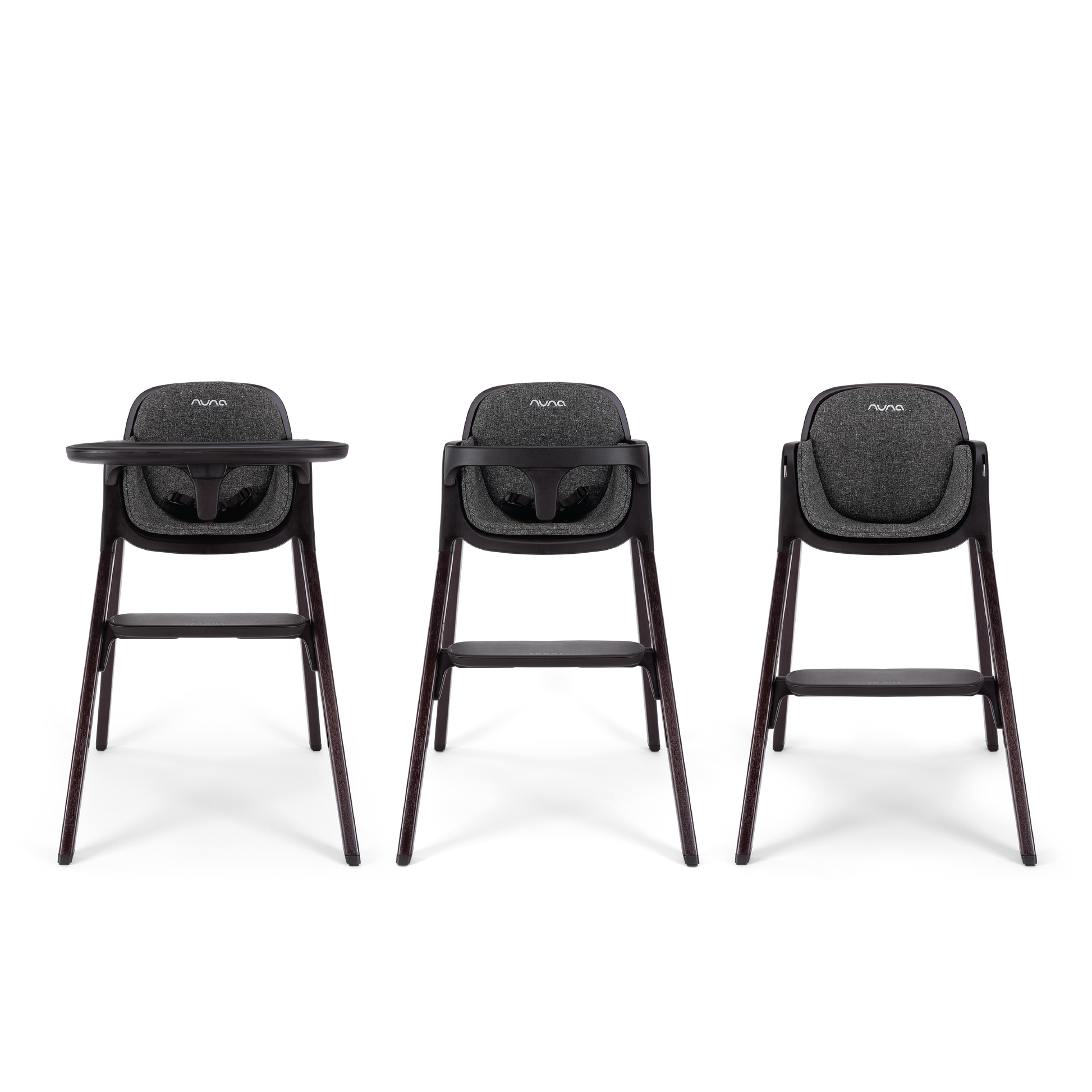 Three nuna bryn highchairs with dark gray fabric seats and sleek wooden legs shown from the front