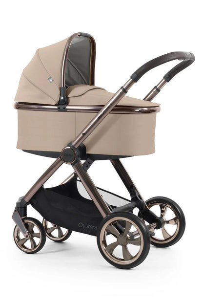 Beige and bronze oyster pram with soft fabric canopy and sturdy metal frame in oyster 4 fawn essentials travel system
