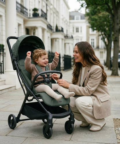 My babiie MBX6 auto-fold compact stroller in forest green with dark green and black lightweight frame and canopy for urban use