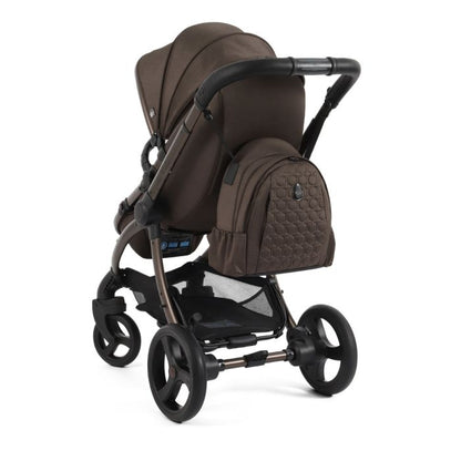 Brown quilted backpack with subtle hexagonal pattern attached to stroller side in egg3 chocolate velvet all stages bundle