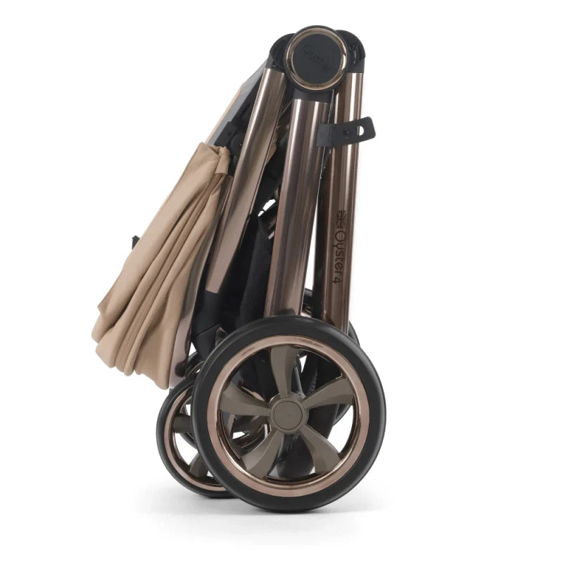 Oyster 4 fawn essentials travel system folding stroller with rose gold frame black wheels and beige fabric canopy