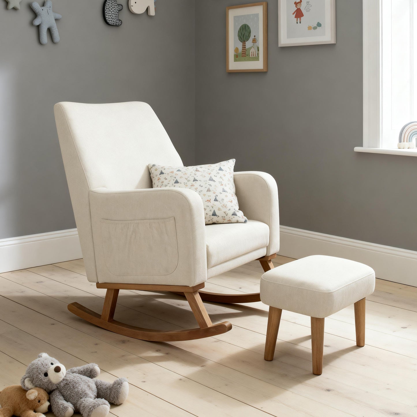 Cream-colored upholstered babymore callie nursing chair and stool with wooden legs and matching ottoman in ivory