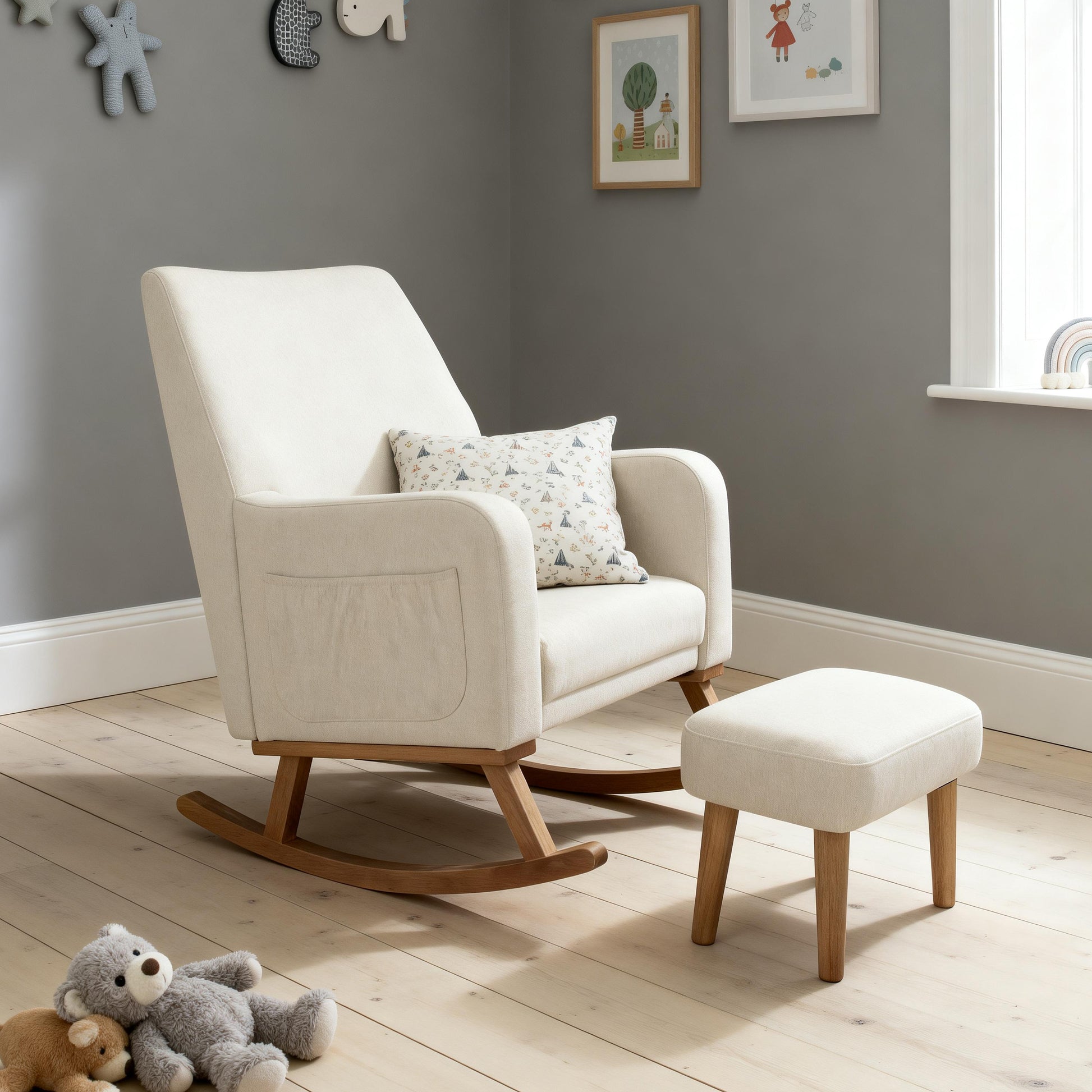 Cream-colored upholstered babymore callie nursing chair and stool with wooden legs and matching ottoman in ivory