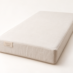 Bebe & Beyond Natural Cot Bed Mattress 140x70cm in cream with organic cotton cover, firm supportive design and branded label.