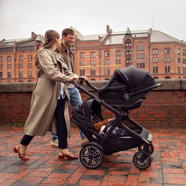 Black nuna PIPA next infant carrier with sleek modern design and sturdy wheels in caviar color