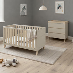 Beige wooden baby crib with slatted sides and angled legs in babymore dante 2 piece nursery room set cashmere
