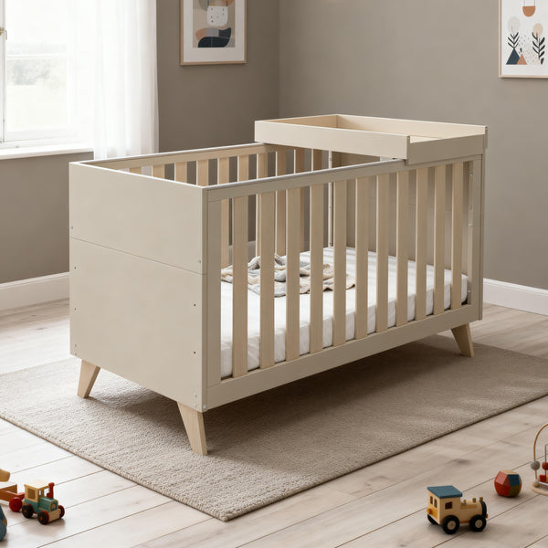 Beige wooden baby crib with slatted sides and matching changing table attachment babymore dante cot bed cashmere