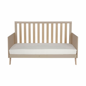 Beige wooden convertible crib with vertical slats and white mattress in babymore dante cashmere nursery set