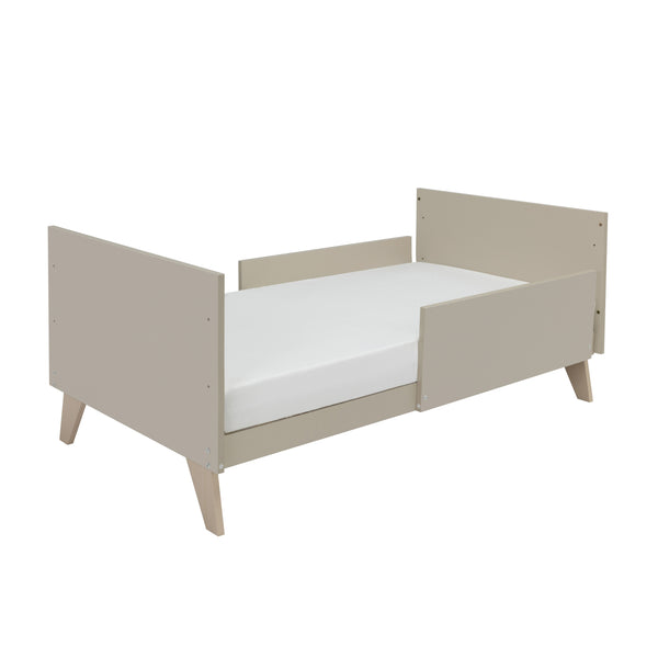 Babymore dante cot bed in cashmere beige with sleek modern design and angled legs featuring a cot top changer
