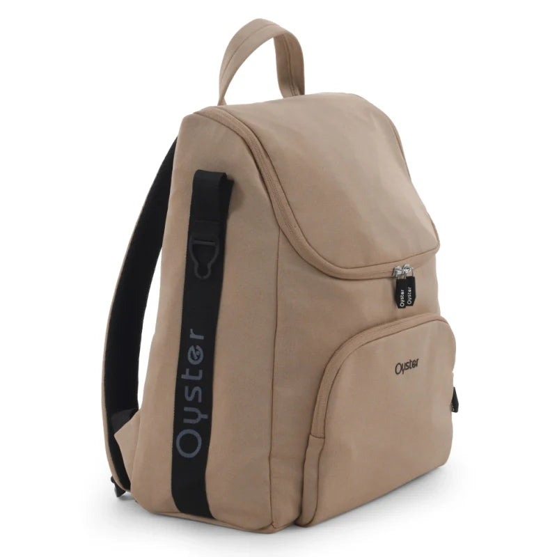 Beige oyster backpack with black strap and zipper pulls in the oyster 4 fawn luxury travel system set