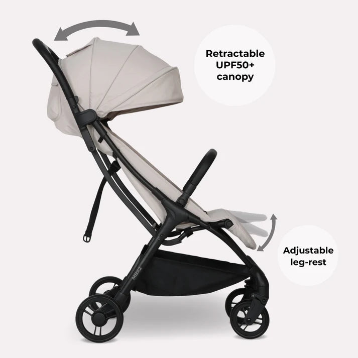 My babiie mbx2 compact stroller in oatmeal beige and black features a foldable design with upf50+ canopy and adjustable leg-rest