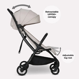 My babiie mbx2 compact stroller in oatmeal beige and black features a foldable design with upf50+ canopy and adjustable leg-rest