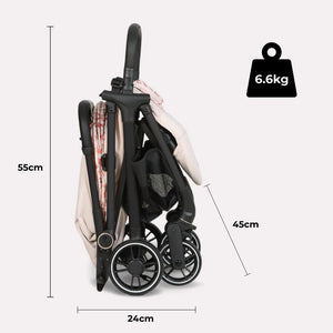 My Babiie MBX6 auto-fold compact stroller in black with beige and red patterned fabric canopy and four wheels