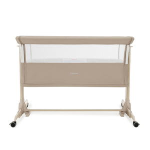 Babymore neera bedside crib in khaki with beige convertible frame mesh sides and black caster wheels for easy mobility