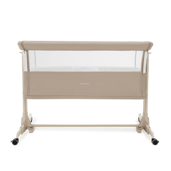 Babymore neera bedside crib in khaki with beige convertible frame mesh sides and black caster wheels for easy mobility