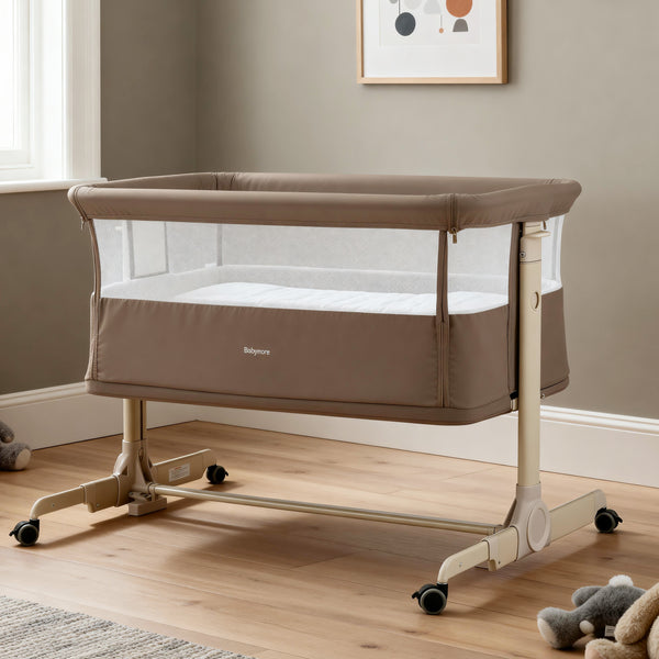 Beige babymore rocking bedside crib with mesh sides and caster wheels in mocha finish for safe infant sleep