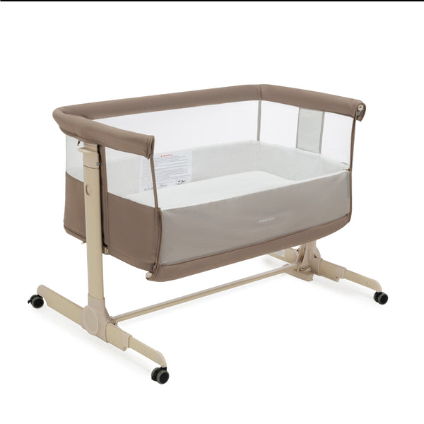 Beige and white babymore neera bedside crib convertible bassinet with mesh sides clear panels and caster wheels