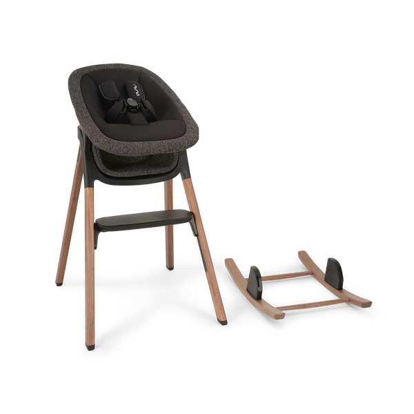 Modern wooden high chair with dark gray textured fabric seat and black safety harness in nuna bryn highchair bundle