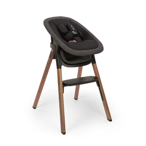Black and gray textured fabric nuna BRYN highchair with wooden legs in the Sanderson newborn rocker bundle
