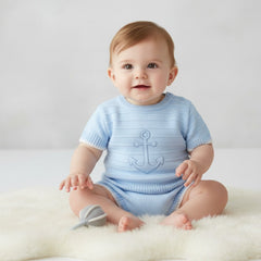 Light blue knitted baby boys onesie with subtle anchor design part of sky blue anchor knit outfit top and jam pant shorts