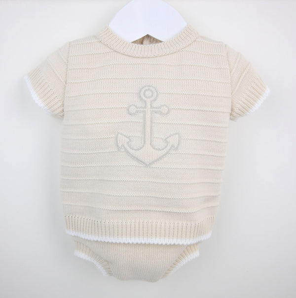Cream-colored knitted baby onesie with subtle anchor embroidery in beige and white anchor baby boys knit outfit set