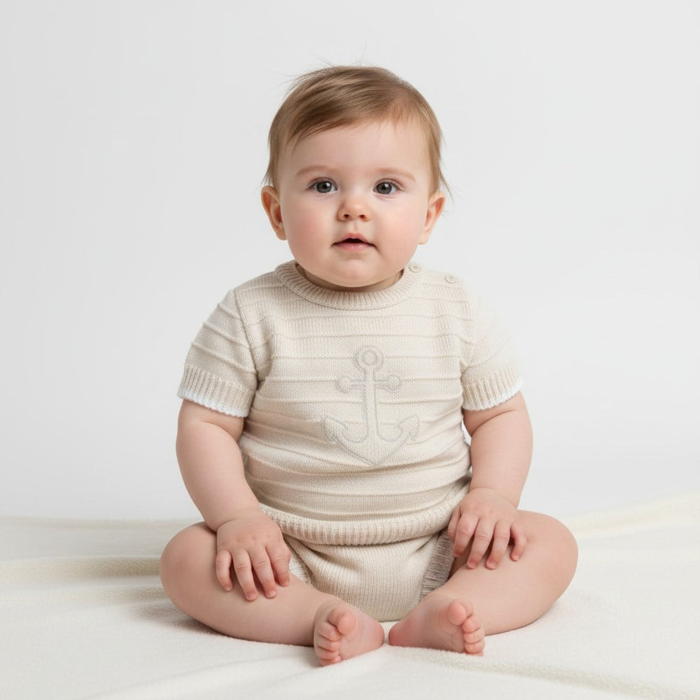 Beige and white anchor baby boys knit outfit with soft cream cream knitted onesie and subtle anchor design on chest