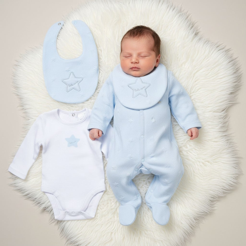 Soft light blue star-patterned baby boys layette set with textured onesie, matching bib, and white bodysuit