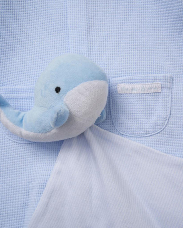 A soft light blue and white plush dolphin toy with gentle expression paired with baby boys whale waffle romper and comforter