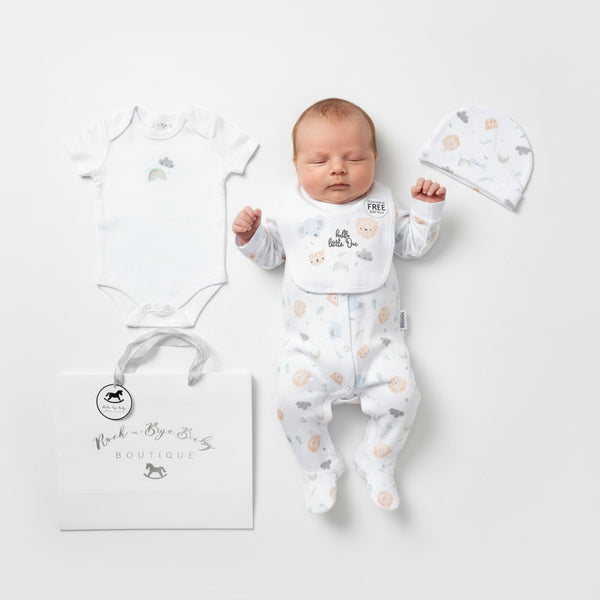 White unisex baby onesie with soft subtle animal print and gentle ruffled neckline from little one layette set
