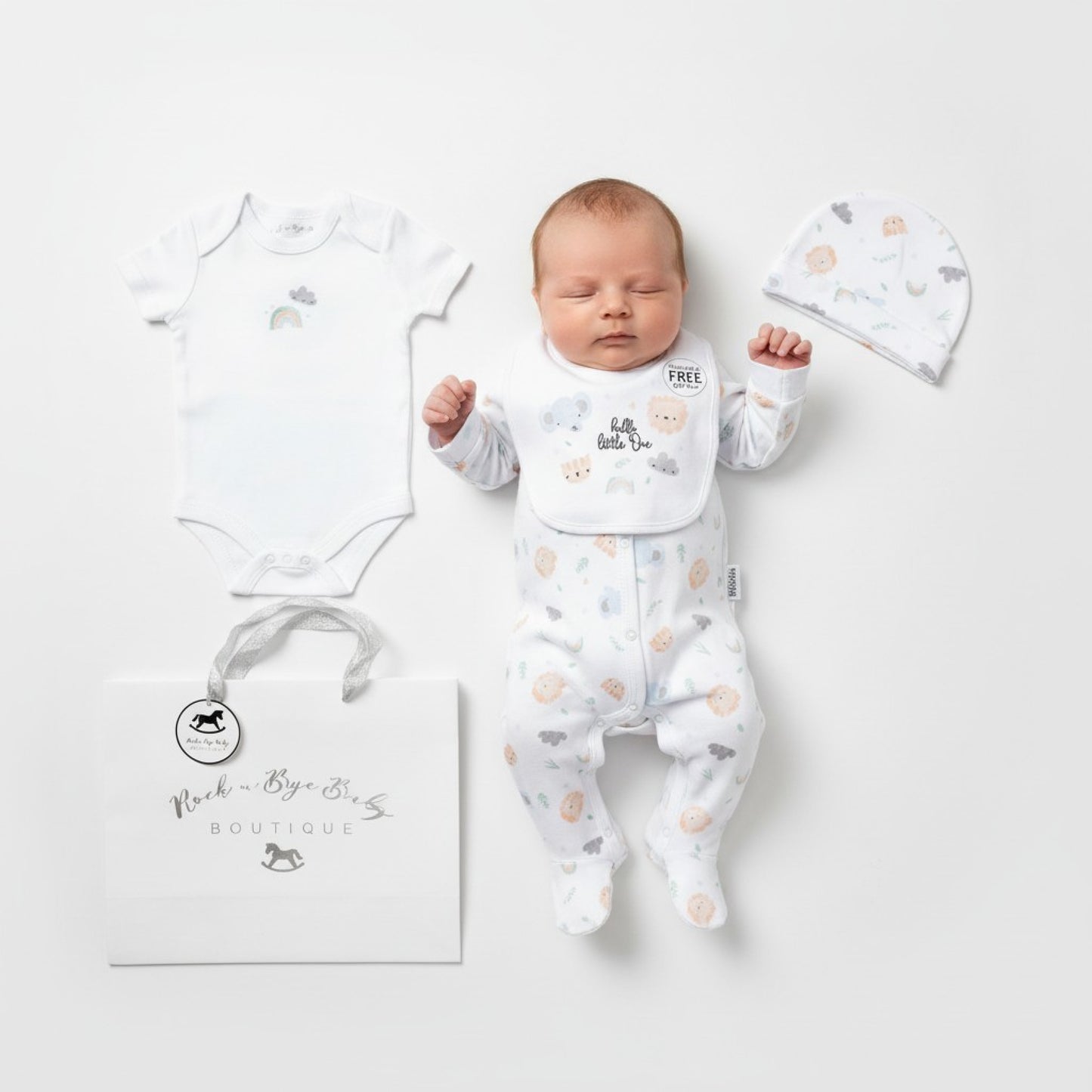 White unisex baby onesie with soft subtle animal print and gentle ruffled neckline from little one layette set