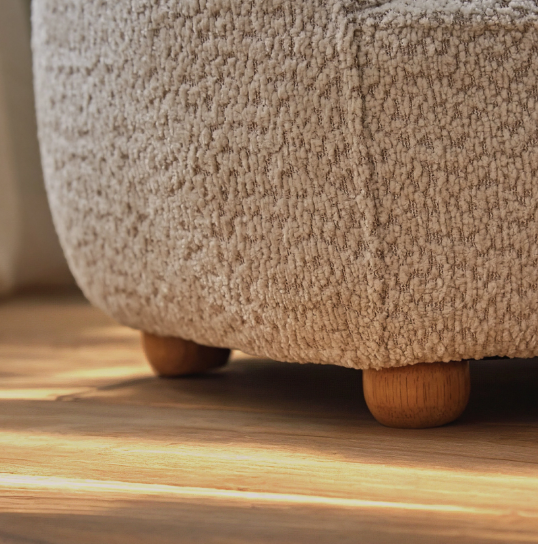 Beige textured boucle fabric ottoman with rounded wooden legs from etta bear kids chair collection mushroom color