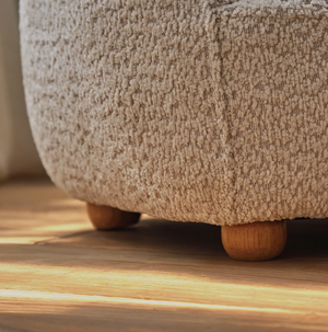 Beige textured boucle fabric ottoman with rounded wooden legs from etta bear kids chair collection mushroom color