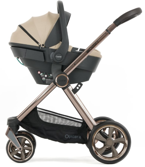 Beige and black oyster 4 infant car seat stroller with metallic bronze frame and multi-spoke wheels in buttermilk color