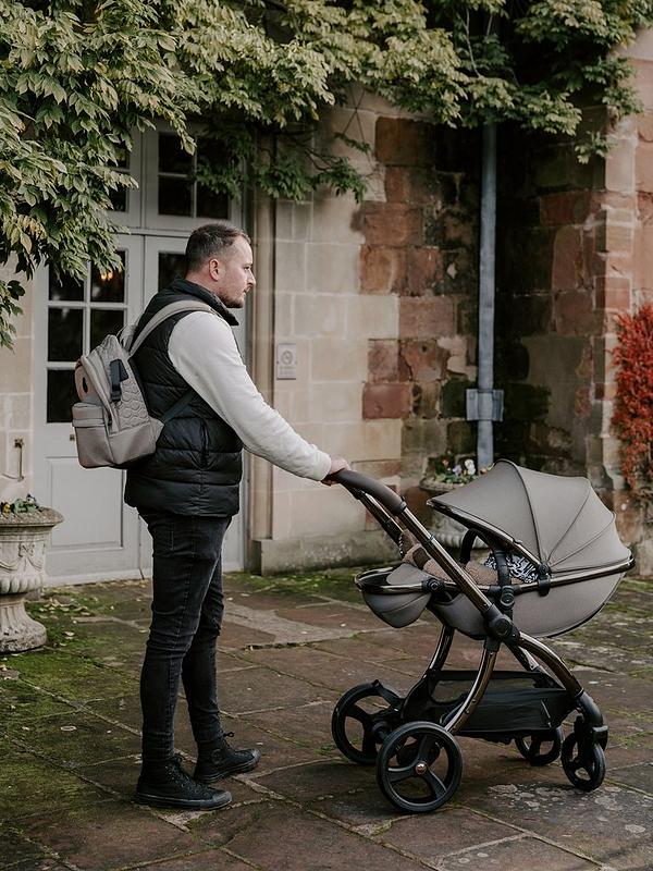 Gray fabric-covered stroller with black metal frame and wheels