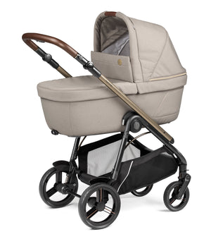 Beige fabric-lined pram with bronze-finished handle and black metal frame in peg perego veloce lite travel system 360 twist i-size bundle astral