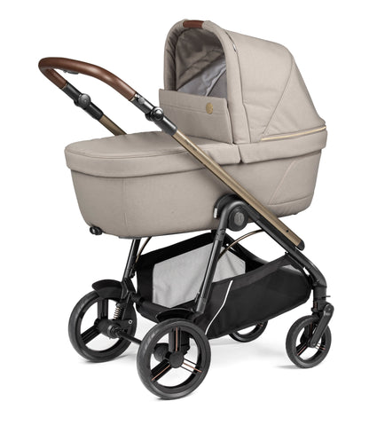 Beige fabric-lined pram with bronze-finished handle and black metal frame in peg perego veloce lite travel system 360 twist i-size bundle astral