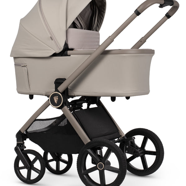 Beige fabric-lined venicci upline 3 pebble 2 in 1 pushchair with black wheels and frame featuring sleek modern design