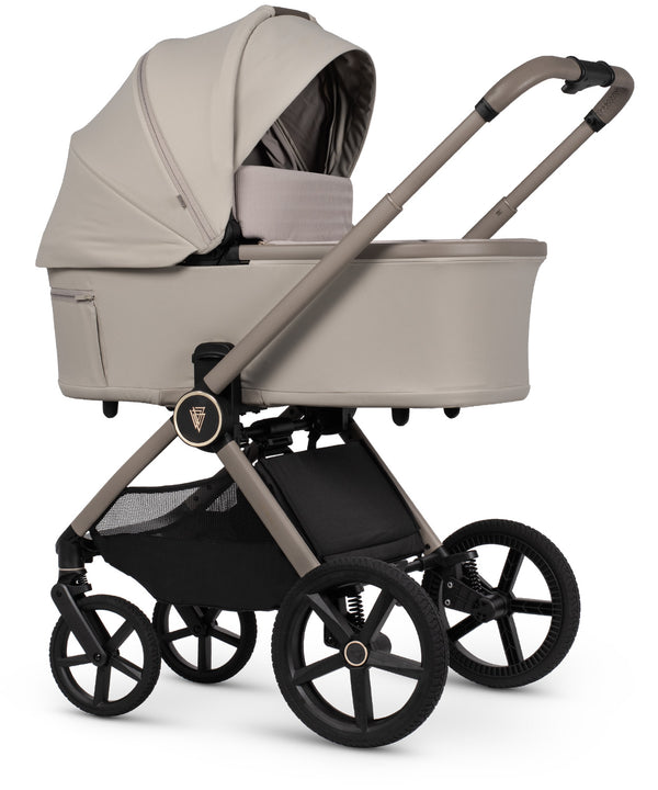 Beige fabric-lined venicci upline 3 travel system pram with black frame and wheels in sleek modern design